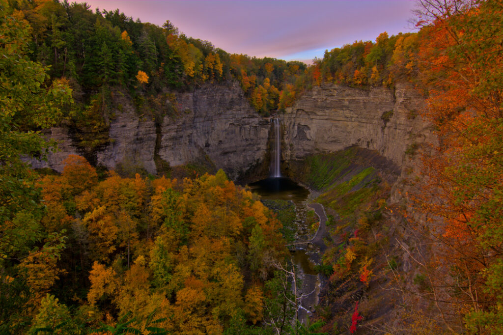 Wide angle photograph of Taughannock Falls during peak fall foliage